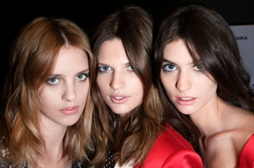 three fashion models backstage